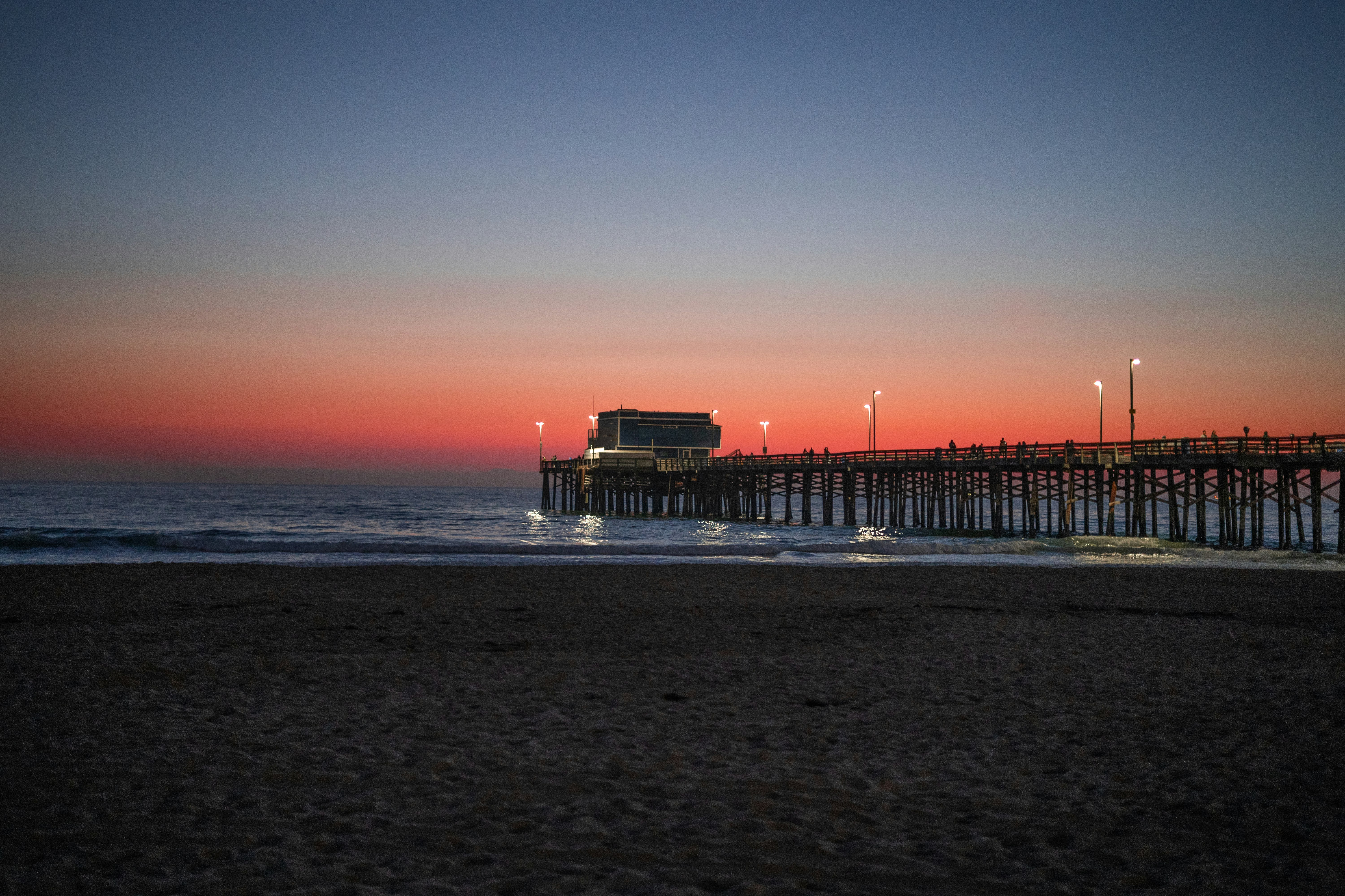 silhouette of people on beach during sunset